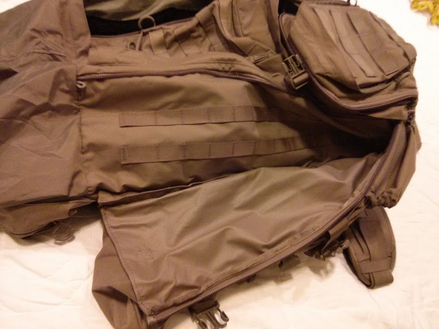 Behind the side pocket of Eberlestock G4